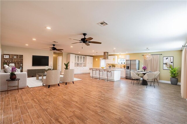 234 Murray Hill Dr, Destrehan, LA 70047 - living room with light wood-type flooring, recessed lighting, baseboards, ceiling fan, and a chandelier