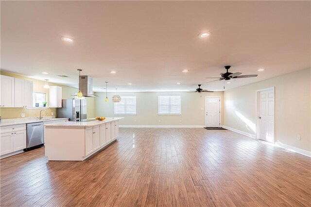 234 Murray Hill Dr, Destrehan, LA 70047 - kitchen with appliances with stainless steel finishes, a center island, white cabinets, light countertops, and recessed lighting