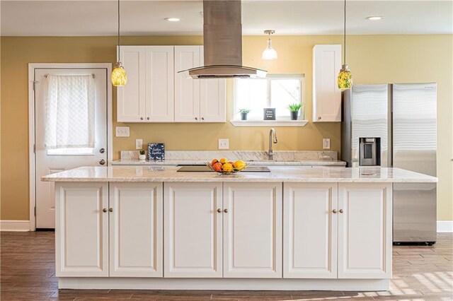 234 Murray Hill Dr, Destrehan, LA 70047 - kitchen featuring island exhaust hood, stainless steel fridge, a center island, a sink, and plenty of natural light