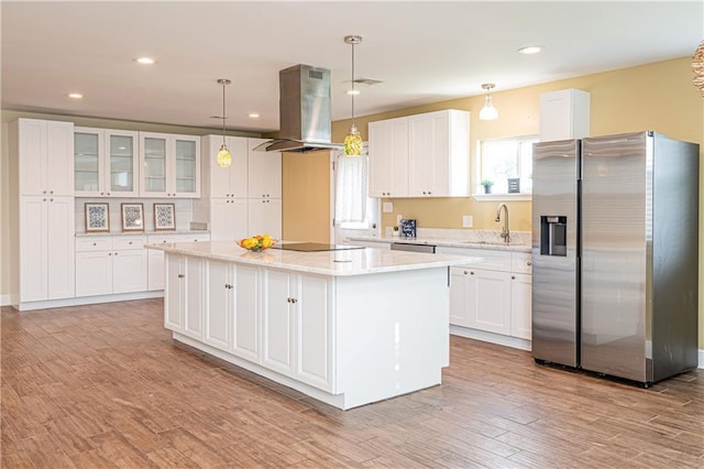 234 Murray Hill Dr, Destrehan, LA 70047 - kitchen featuring stainless steel appliances, island range hood, a sink, a kitchen island, and white cabinetry