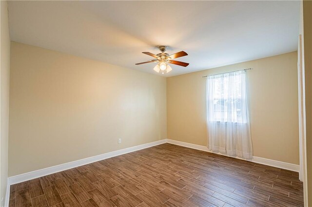 234 Murray Hill Dr, Destrehan, LA 70047 - spare room featuring dark wood-style flooring, ceiling fan, and baseboards