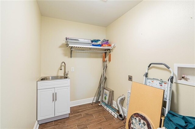 234 Murray Hill Dr, Destrehan, LA 70047 - laundry area featuring electric dryer hookup, dark wood-style flooring, cabinet space, baseboards, and hookup for a washing machine