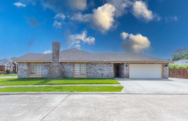 3701 Red Cypress Dr, New Orleans, LA 70131 - single story home with an attached garage, french doors, driveway, a chimney, and brick siding