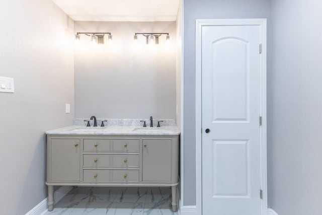 3701 Red Cypress Dr, New Orleans, LA 70131 - bathroom featuring marble look tiles, double vanity, and baseboards
