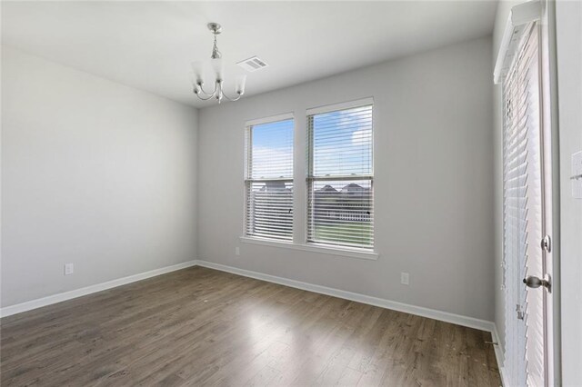 728 Lakeshore Village Dr, Slidell, LA 70461 - spare room with a chandelier, baseboards, and wood finished floors
