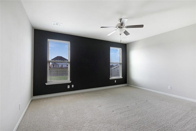 728 Lakeshore Village Dr, Slidell, LA 70461 - carpeted empty room with healthy amount of natural light, ceiling fan, and baseboards