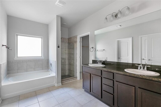 728 Lakeshore Village Dr, Slidell, LA 70461 - bathroom featuring tile patterned floors, double vanity, a garden tub, and a stall shower