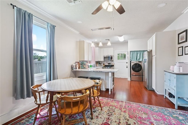 220 Moss Ln, River Ridge, LA 70123 - dining area with healthy amount of natural light, a textured ceiling, dark wood-type flooring, and a ceiling fan