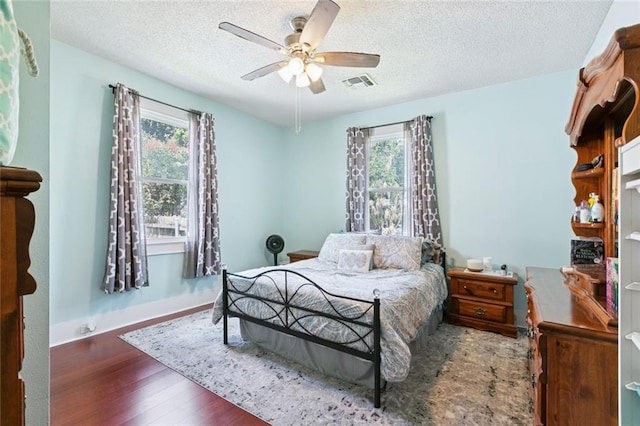 220 Moss Ln, River Ridge, LA 70123 - bedroom with wood finished floors, a textured ceiling, a ceiling fan, and baseboards