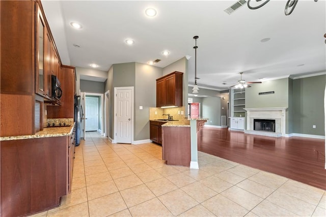 118 Windward Passage St, Slidell, LA 70458 - kitchen with a ceiling fan, a sink, black microwave, a peninsula, and light tile patterned floors