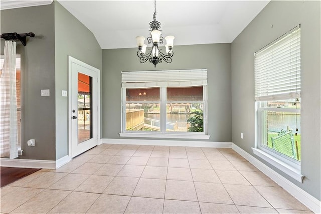 118 Windward Passage St, Slidell, LA 70458 - unfurnished dining area featuring a chandelier, tile patterned flooring, lofted ceiling, and baseboards