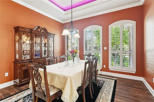 422 Kensington Blvd, Slidell, LA 70458 - dining area with dark wood-style floors, baseboards, crown molding, and a raised ceiling