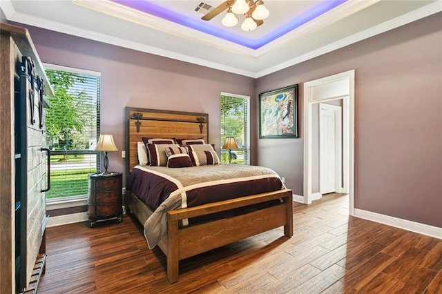 422 Kensington Blvd, Slidell, LA 70458 - bedroom with a raised ceiling, multiple windows, ornamental molding, wood finished floors, and baseboards