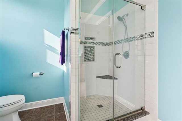 422 Kensington Blvd, Slidell, LA 70458 - bathroom featuring toilet, baseboards, a stall shower, and tile patterned floors