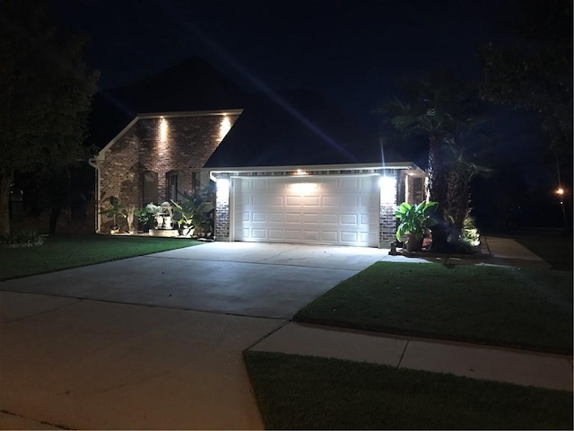 422 Kensington Blvd, Slidell, LA 70458 - view of front facade with concrete driveway, brick siding, a garage, and a lawn