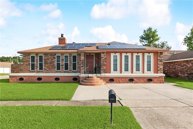 4060 S Windmere St, Harvey, LA 70058 - ranch-style home featuring roof mounted solar panels, a front lawn, a chimney, and brick siding