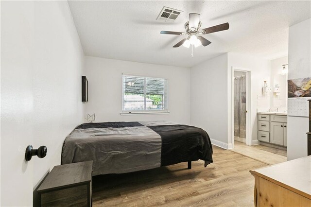 4060 S Windmere St, Harvey, LA 70058 - bedroom featuring light wood-type flooring, baseboards, ensuite bathroom, and ceiling fan