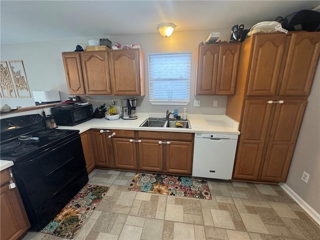 6035-37 Colbert St, New Orleans, LA 70124 - kitchen featuring black appliances, a sink, light countertops, and brown cabinetry