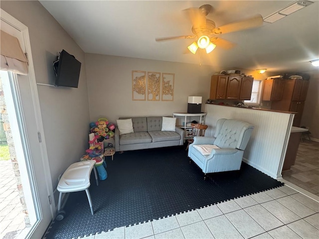 6035-37 Colbert St, New Orleans, LA 70124 - living room with healthy amount of natural light, a ceiling fan, light tile patterned flooring, and light carpet