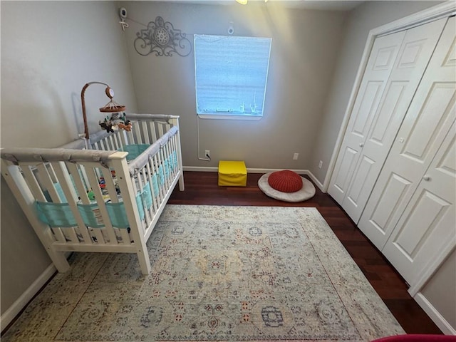6035-37 Colbert St, New Orleans, LA 70124 - bedroom featuring wood finished floors, baseboards, a crib, and a closet