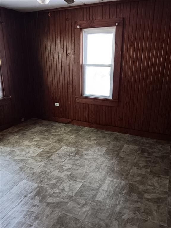 802 Varnado St, Franklinton, LA 70438 - spare room with wooden walls, a ceiling fan, and tile patterned floors