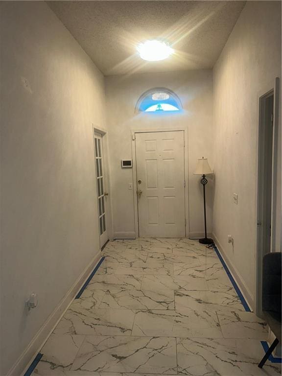 2227 Pine Valley Dr, La Place, LA 70068 - entryway featuring baseboards, light marble finish flooring, and a textured ceiling