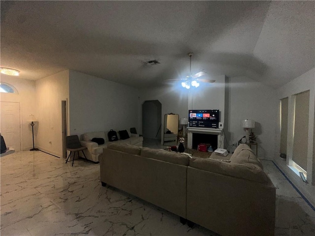 2227 Pine Valley Dr, La Place, LA 70068 - living room featuring ceiling fan, a textured ceiling, light marble finish floors, and vaulted ceiling