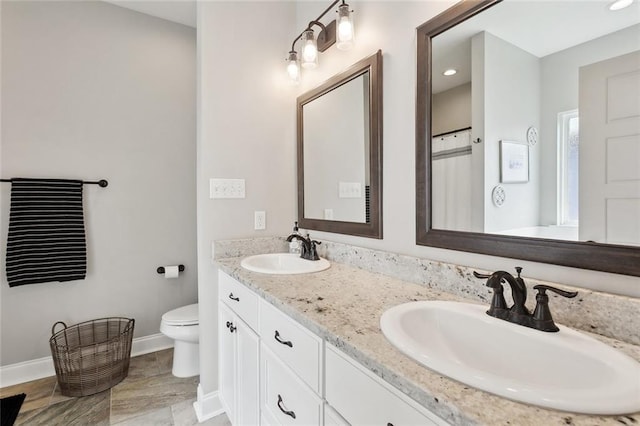 139 Abita Oaks Loop, Abita Springs, LA 70420 - bathroom featuring toilet, double vanity, baseboards, and recessed lighting