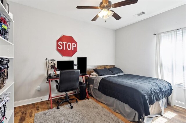139 Abita Oaks Loop, Abita Springs, LA 70420 - bedroom featuring wood finished floors, a desk, a ceiling fan, and baseboards