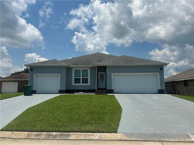 131 Belle Grove Dr, La Place, LA 70068 - ranch-style home with an attached garage, concrete driveway, and a front yard