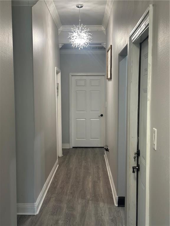 131 Belle Grove Dr, La Place, LA 70068 - corridor with ornamental molding, dark wood-style floors, and a chandelier