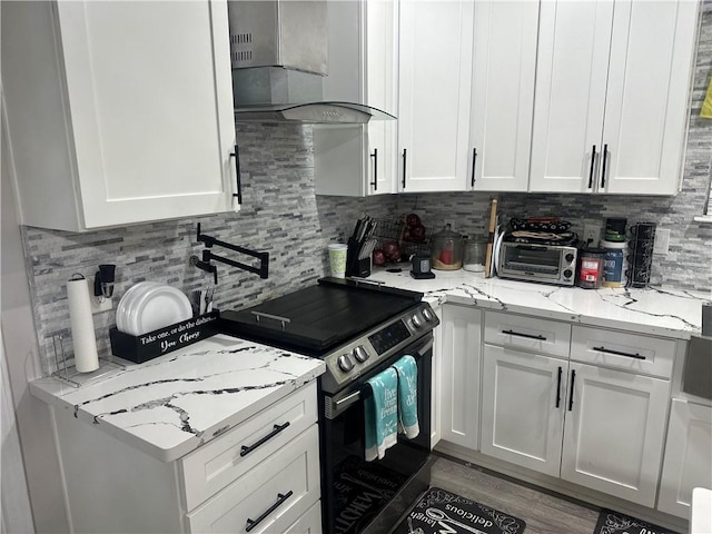 131 Belle Grove Dr, La Place, LA 70068 - kitchen featuring wall chimney range hood, stainless steel electric range, white cabinetry, and tasteful backsplash