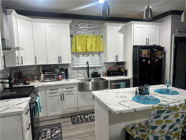 131 Belle Grove Dr, La Place, LA 70068 - kitchen with freestanding refrigerator, range with electric stovetop, wall chimney range hood, and white cabinets