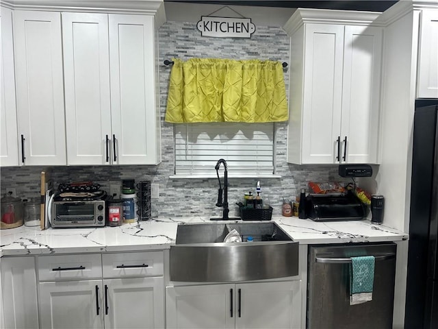 131 Belle Grove Dr, La Place, LA 70068 - kitchen featuring stainless steel dishwasher, white cabinetry, backsplash, freestanding refrigerator, and light stone counters