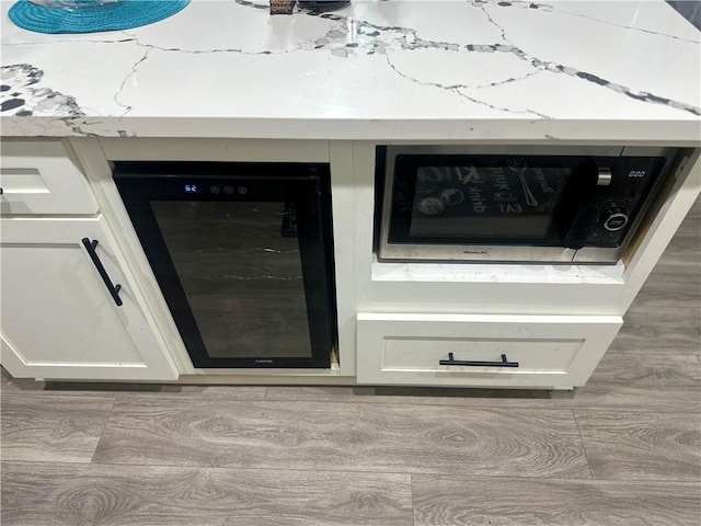 131 Belle Grove Dr, La Place, LA 70068 - detailed view of beverage cooler, stainless steel microwave, and white cabinets