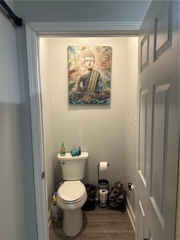 131 Belle Grove Dr, La Place, LA 70068 - bathroom with toilet and wood finished floors
