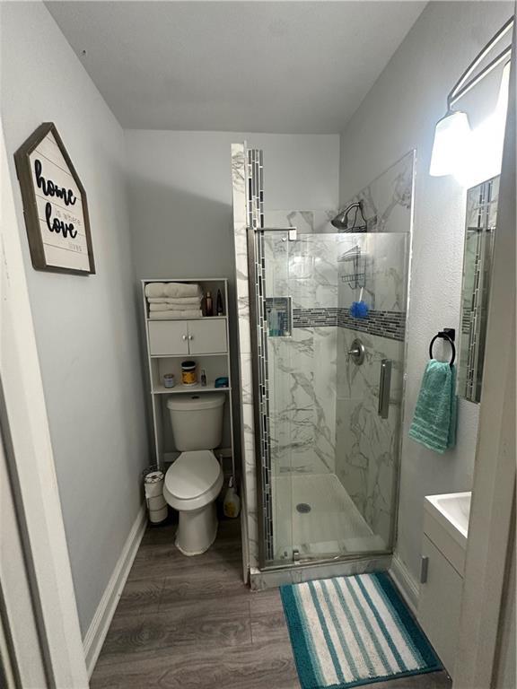 131 Belle Grove Dr, La Place, LA 70068 - full bath featuring wood finished floors, a marble finish shower, and vanity
