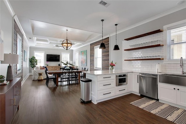 637 S Dupre St, New Orleans, LA 70119 - kitchen featuring stainless steel appliances, a chandelier, a sink, a peninsula, and white cabinets