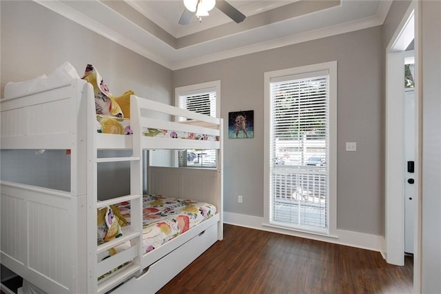 637 S Dupre St, New Orleans, LA 70119 - bedroom featuring dark wood-type flooring, multiple windows, a tray ceiling, crown molding, and baseboards