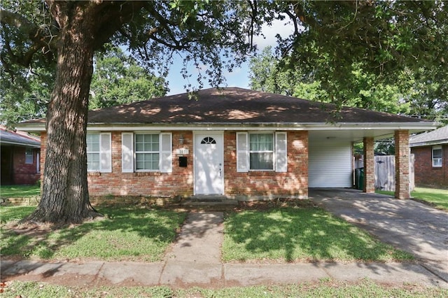 709 Fielding Ave, Gretna, LA 70056 - single story home with driveway, a carport, brick siding, and a front lawn