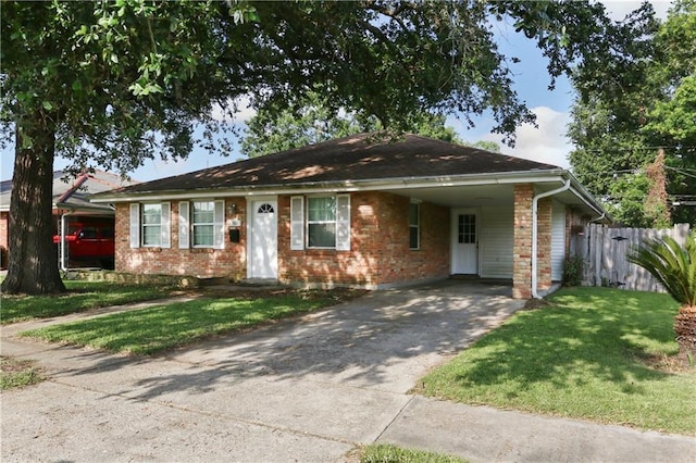 709 Fielding Ave, Gretna, LA 70056 - ranch-style house with driveway, an attached carport, and brick siding
