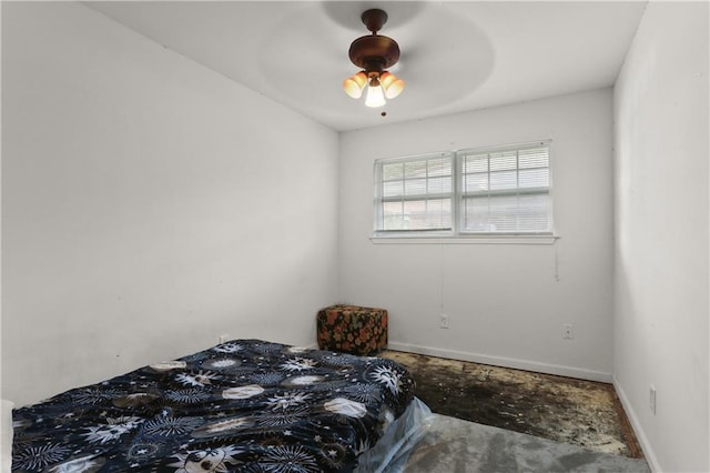 709 Fielding Ave, Gretna, LA 70056 - bedroom featuring baseboards, unfinished concrete floors, and ceiling fan