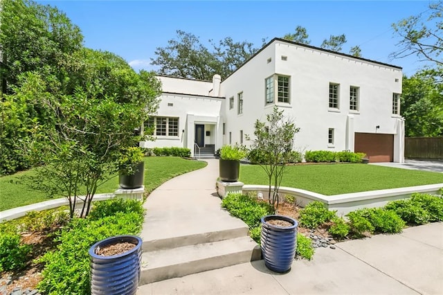 3 Fairview Ct, Metairie, LA 70005 - view of front facade with a front yard, stucco siding, a garage, and driveway