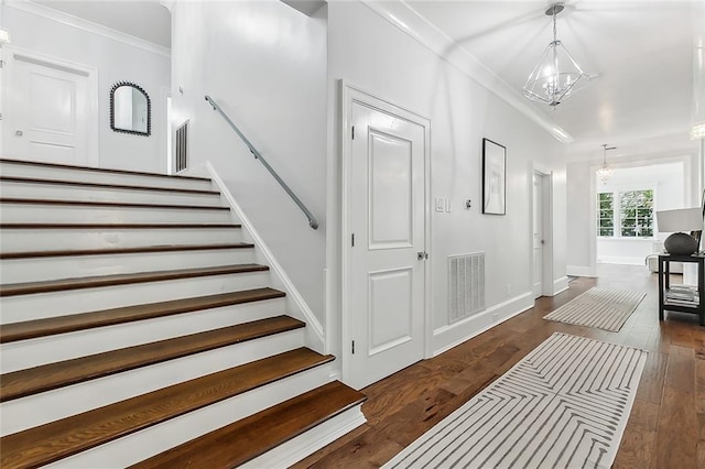 3 Fairview Ct, Metairie, LA 70005 - stairs featuring a chandelier, ornamental molding, wood-type flooring, and baseboards