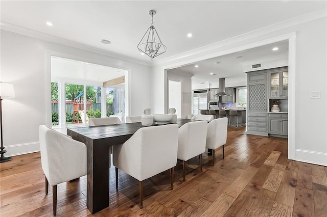 3 Fairview Ct, Metairie, LA 70005 - dining room featuring dark wood-style flooring, ornamental molding, baseboards, and recessed lighting