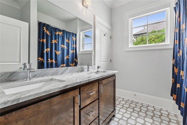 3 Fairview Ct, Metairie, LA 70005 - full bath with tile patterned floors, healthy amount of natural light, double vanity, and baseboards