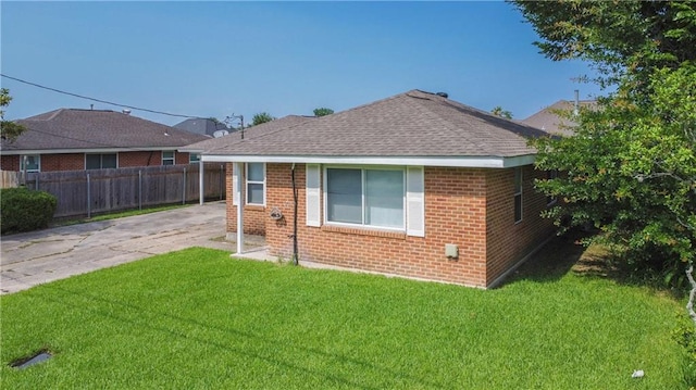 208 Magnolia Ave, La Place, LA 70068 - rear view of property with brick siding, roof with shingles, and driveway
