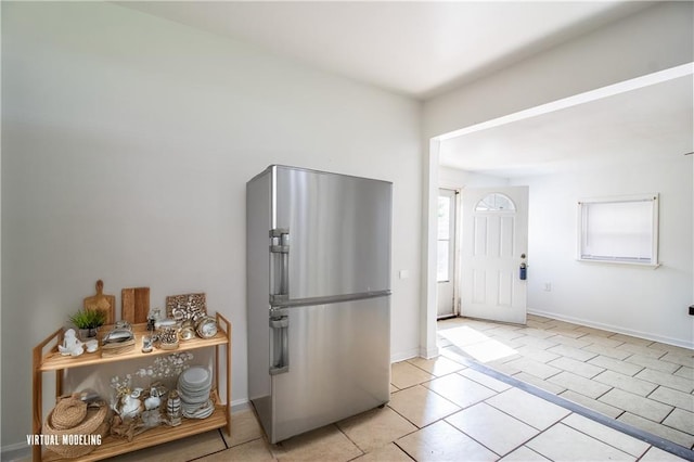 208 Magnolia Ave, La Place, LA 70068 - kitchen with freestanding refrigerator, light tile patterned floors, and baseboards