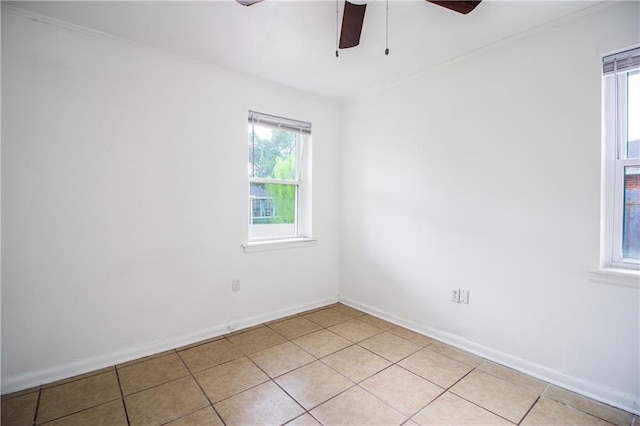 208 Magnolia Ave, La Place, LA 70068 - empty room featuring a ceiling fan, healthy amount of natural light, baseboards, ornamental molding, and light tile patterned flooring