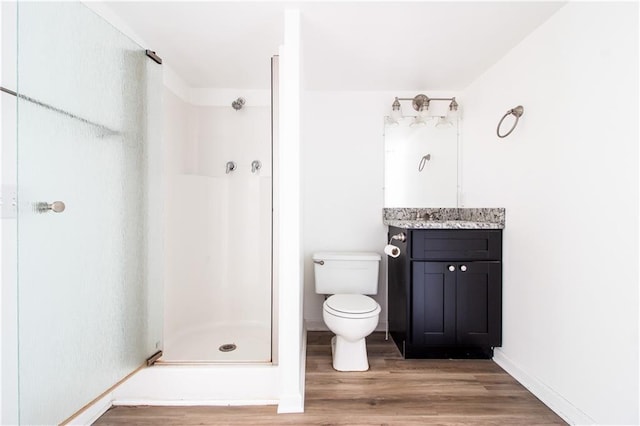 208 Magnolia Ave, La Place, LA 70068 - bathroom with wood finished floors, a shower stall, toilet, vanity, and baseboards